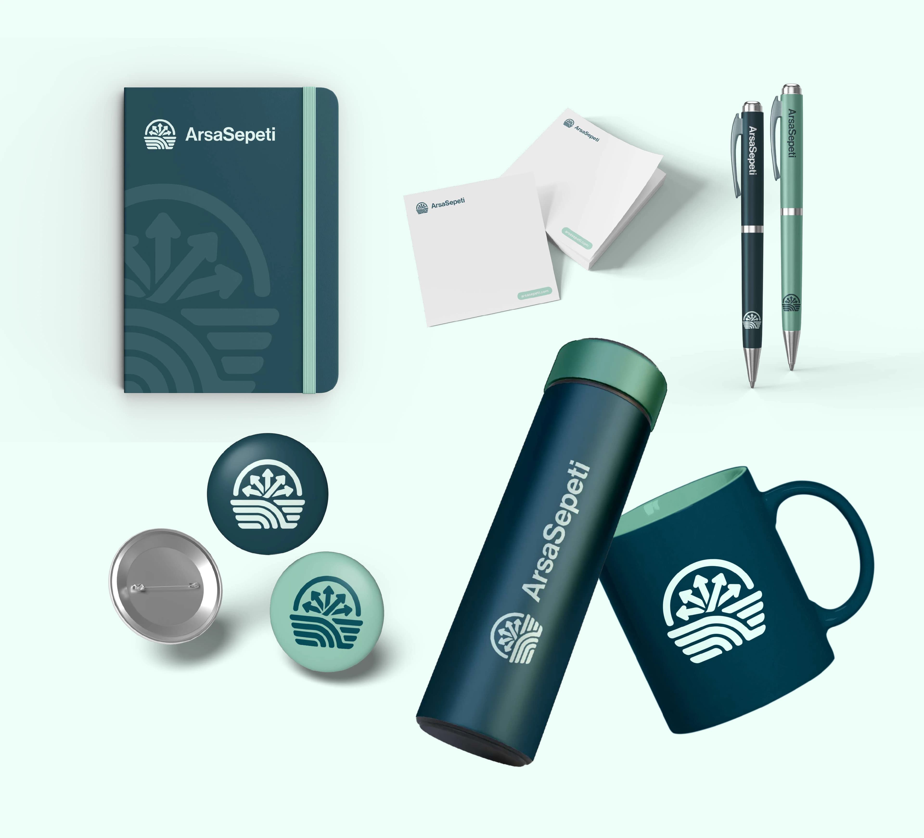 Promotional items: notebook, pens, notepads, badges, a flask and a mug with the ArsaSepeti logo