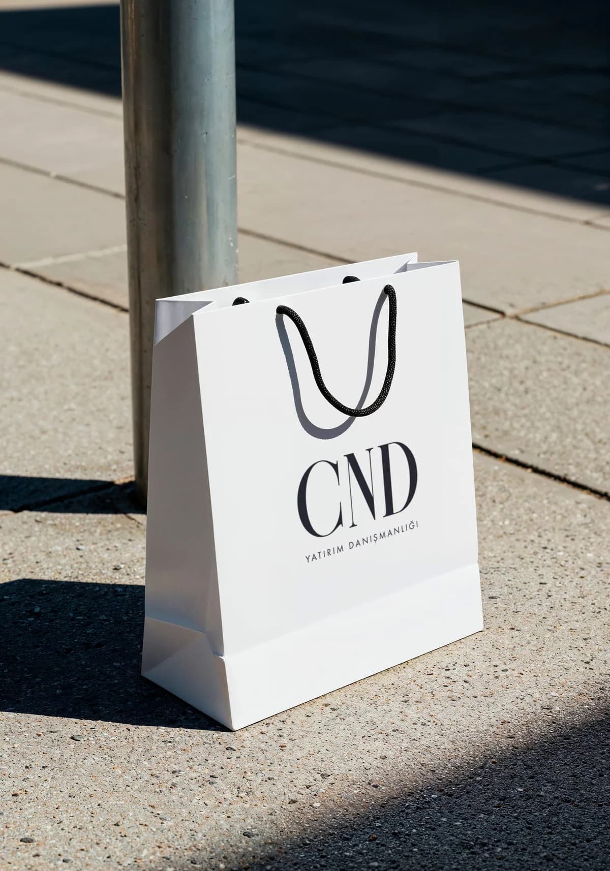 White CND shopping bag on a pavement