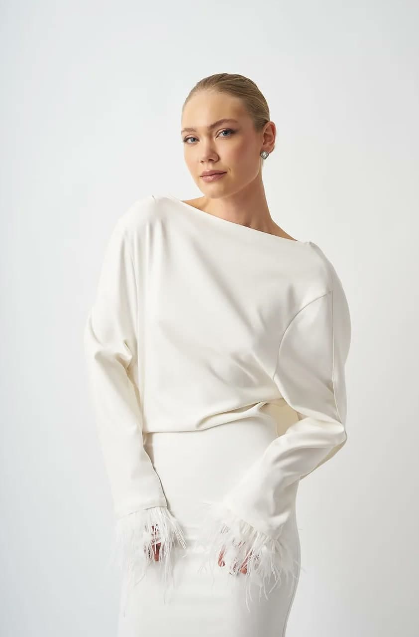Original studio shot of the white feather-cuff dress