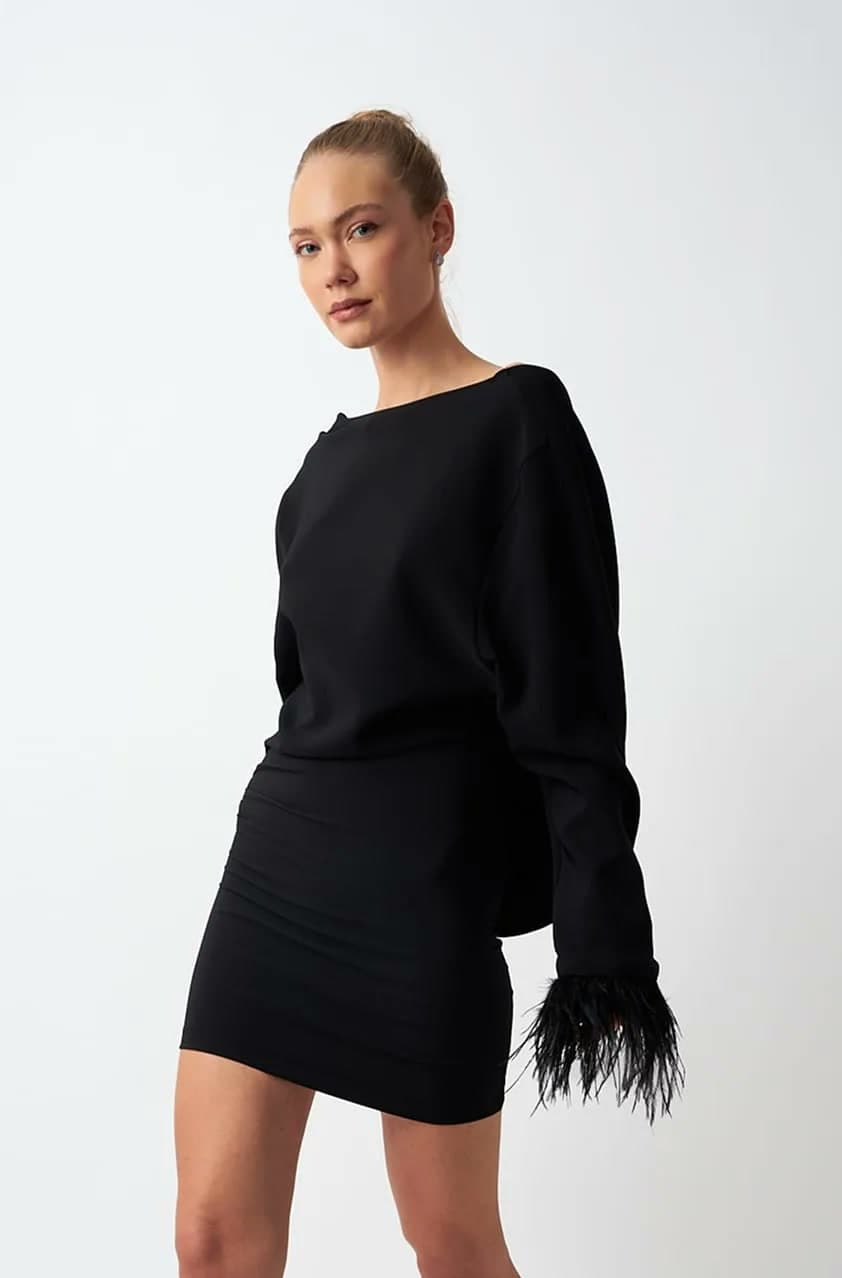 Original studio shot of the black dress with feather cuffs