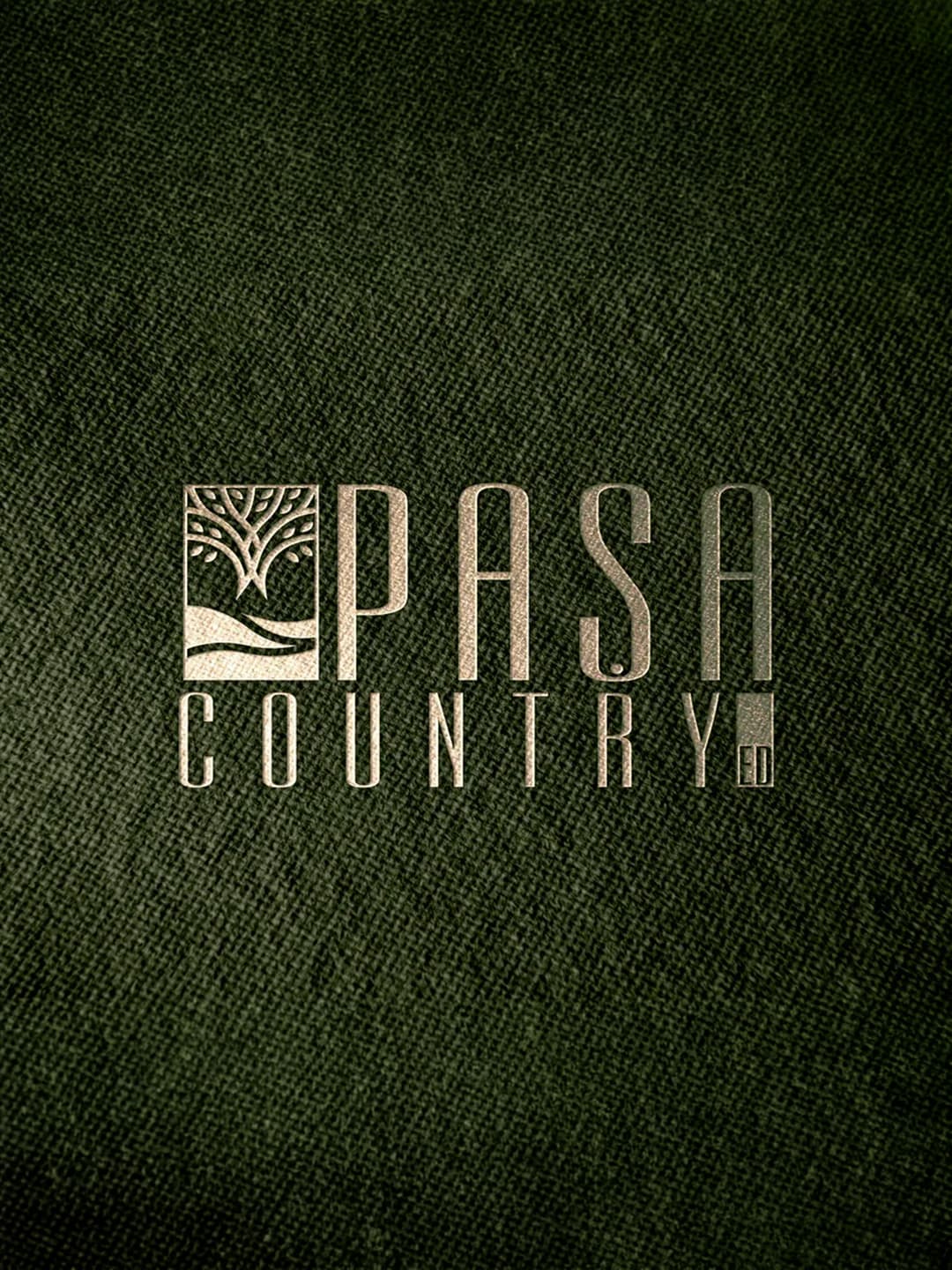 Paşa Country logo embossed in gold on dark green fabric